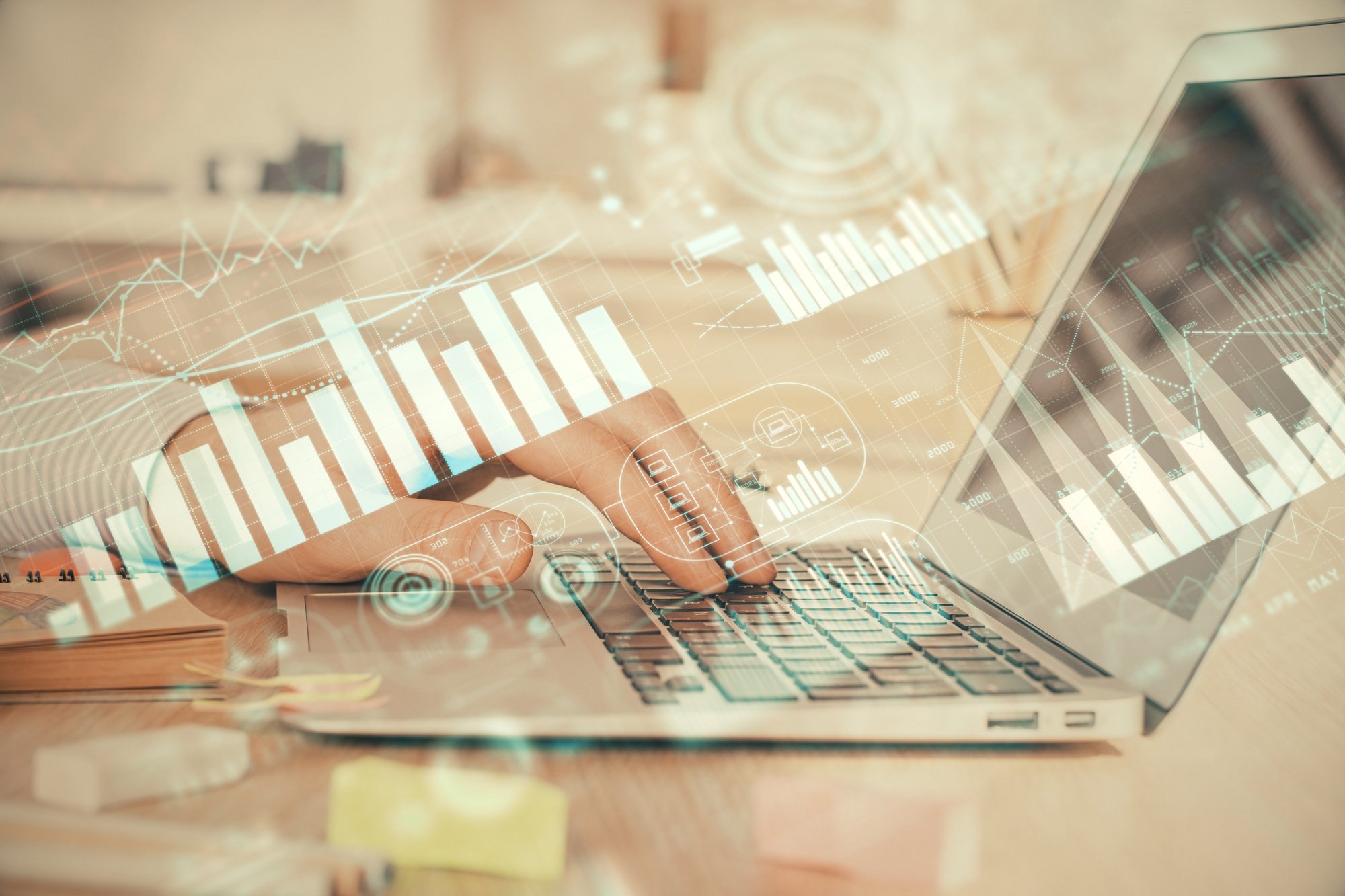 Double exposure of stock market graph with man working on laptop on background. Concept of financial analysis